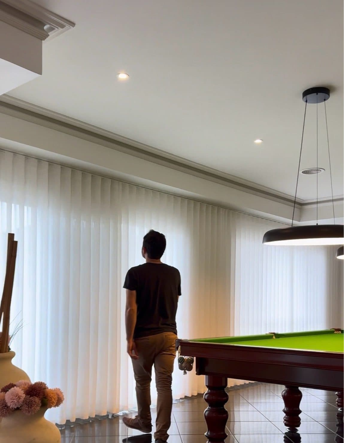 S-fold sheer curtains running wall to wall in a games room