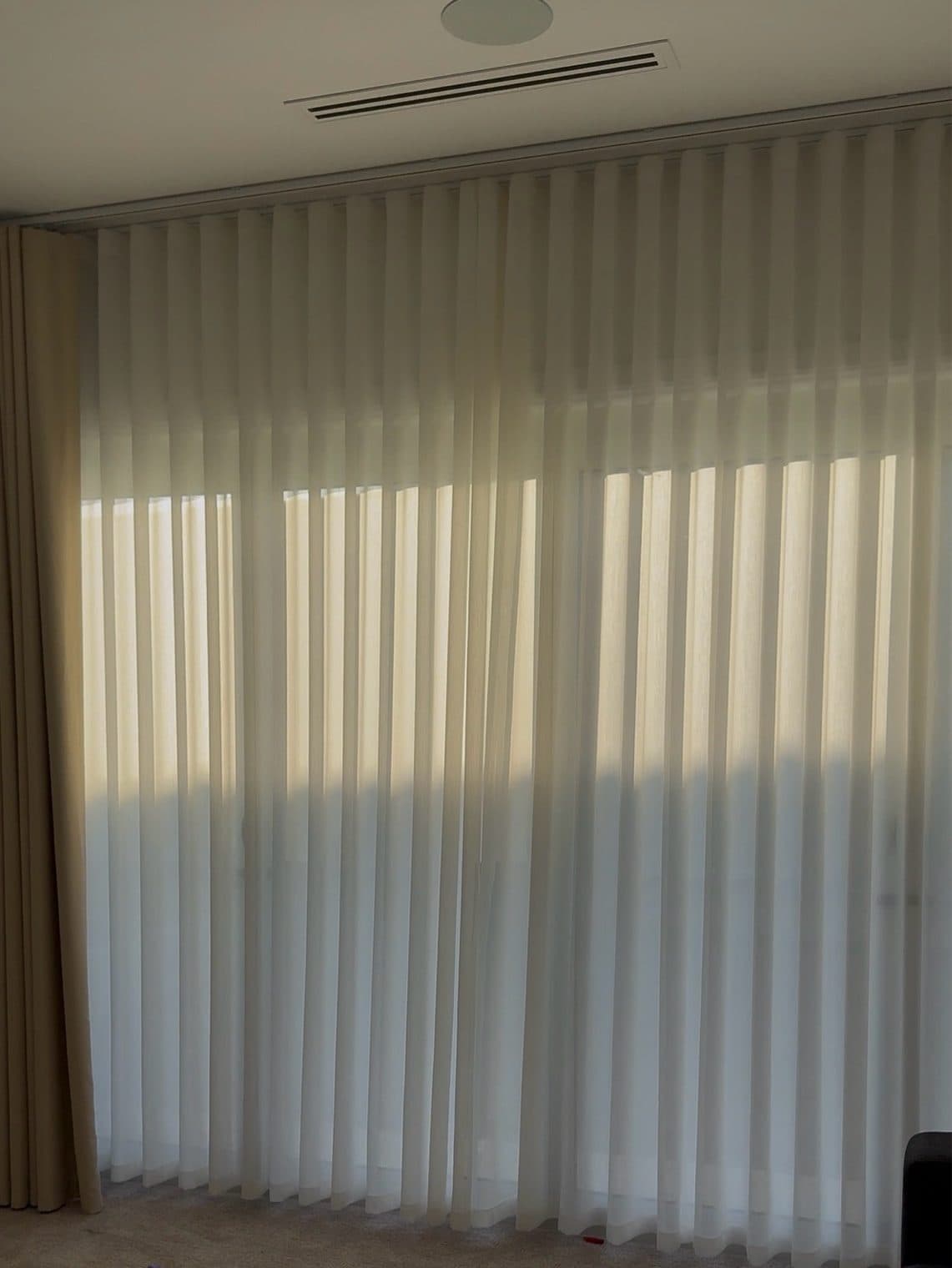 Blockout curtain layered with an S-fold sheer in a living room