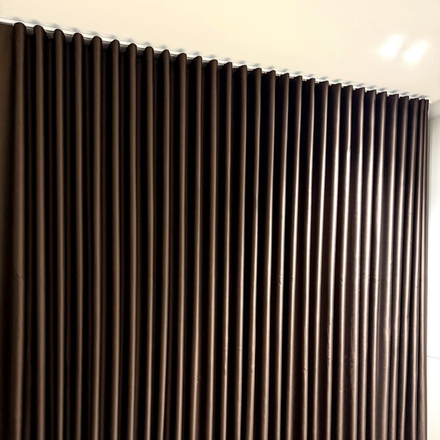 Full blockout curtains in chocolate brown in a bedroom