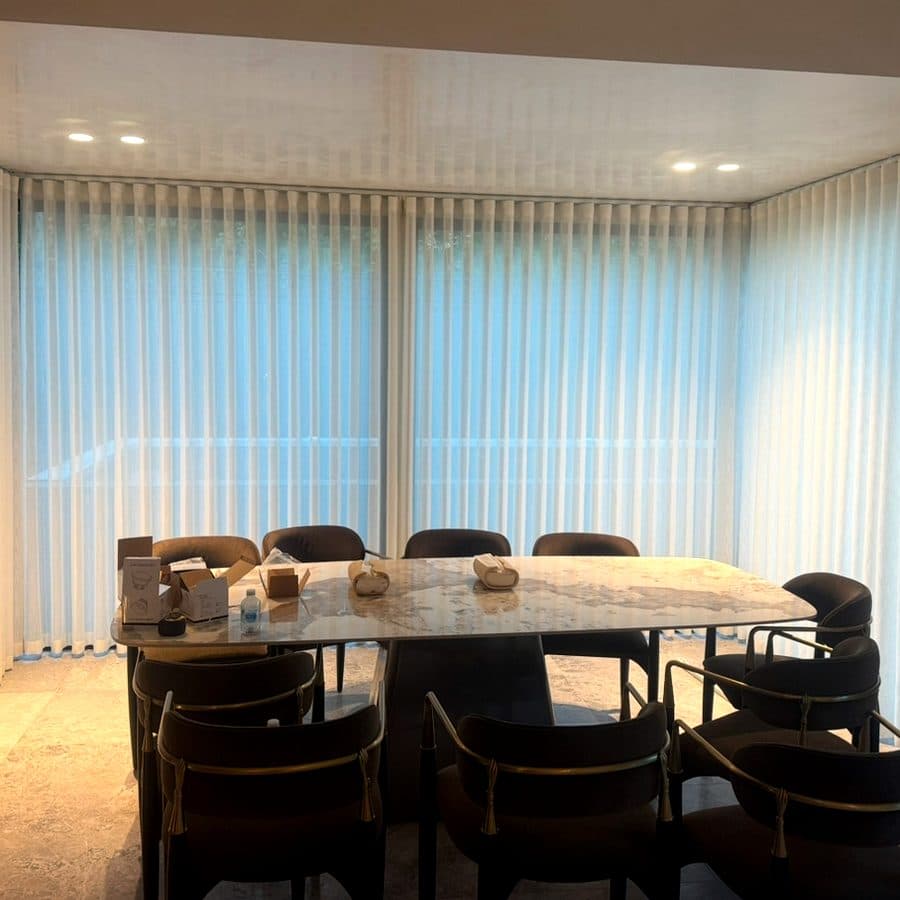 Floor-length white sheers in a contemporary dining room