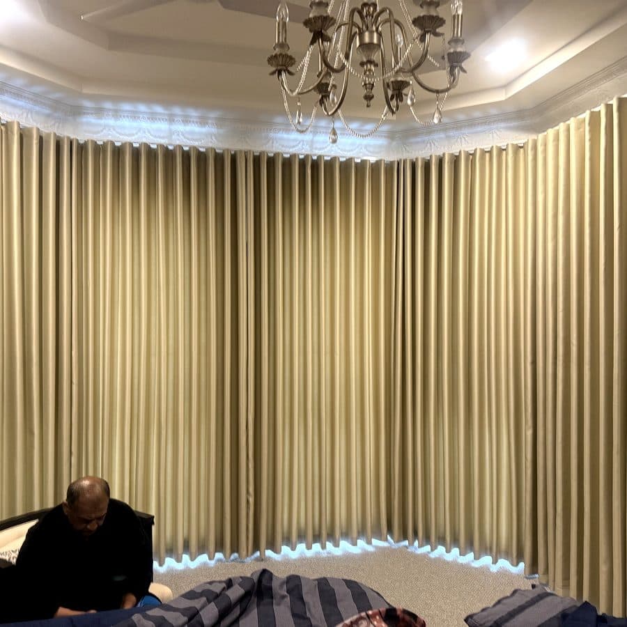 Floor-to-ceiling curtains wrapping a luxury bedroom